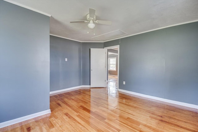 unfurnished room featuring ceiling fan, light wood-type flooring, and ornamental molding