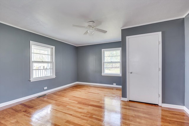 empty room with light wood-type flooring, ceiling fan, and ornamental molding