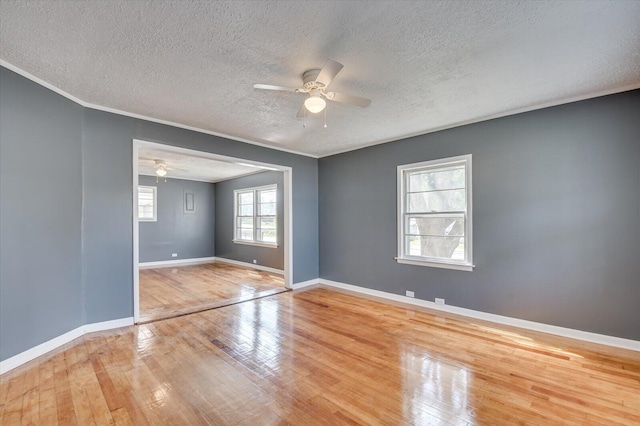 unfurnished bedroom with a textured ceiling, hardwood / wood-style flooring, and ceiling fan