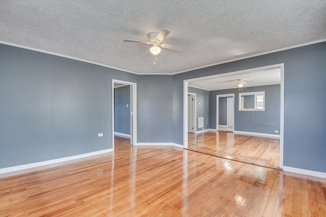 empty room with a textured ceiling, hardwood / wood-style flooring, ceiling fan, and ornamental molding