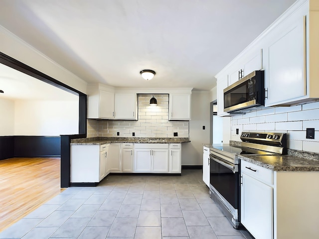 1952 Satcher Blvd, Augusta, GA 30906 - kitchen with stainless steel appliances, dark countertops, backsplash, and white cabinetry