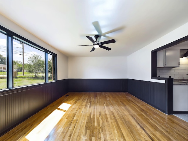 1952 Satcher Blvd, Augusta, GA 30906 - unfurnished room featuring light wood-type flooring, a wainscoted wall, and ceiling fan