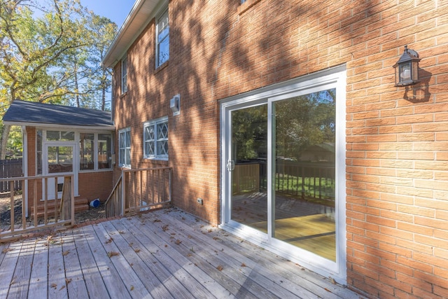 wooden deck with a sunroom