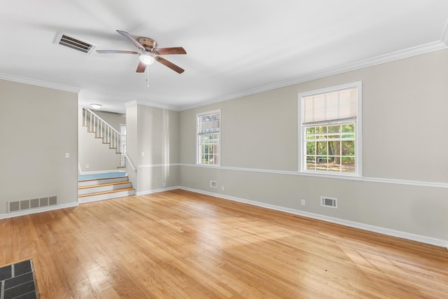 unfurnished room featuring light wood-type flooring, a wealth of natural light, crown molding, and ceiling fan