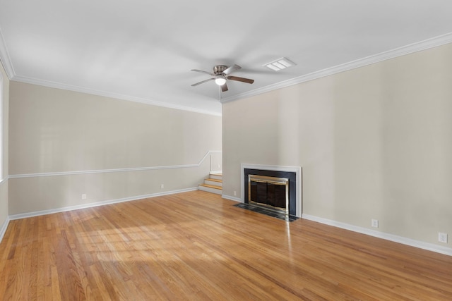 unfurnished living room featuring ceiling fan, light wood-type flooring, and crown molding