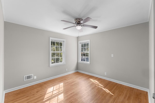 spare room featuring light hardwood / wood-style floors, ceiling fan, and ornamental molding