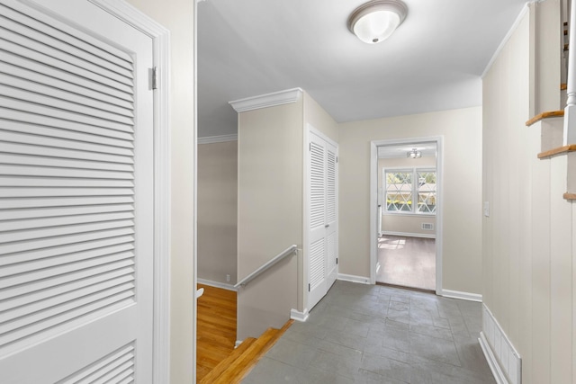 corridor featuring tile patterned floors and ornamental molding