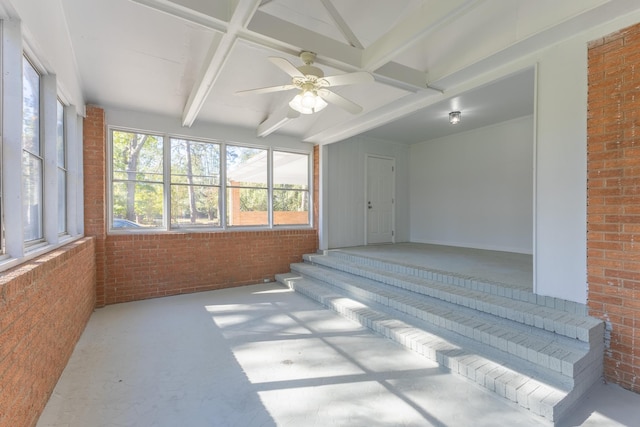 interior space with beam ceiling and ceiling fan