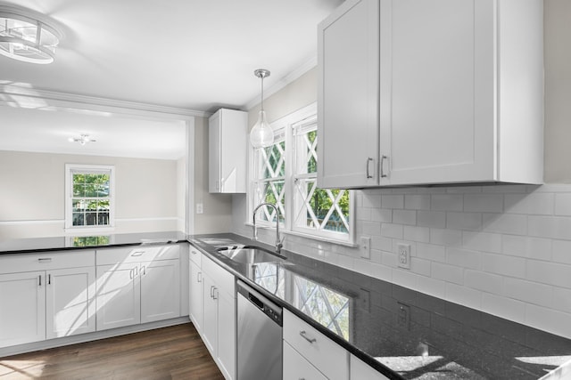 kitchen with stainless steel dishwasher, decorative light fixtures, white cabinetry, and sink