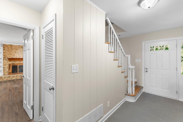 entrance foyer featuring a brick fireplace