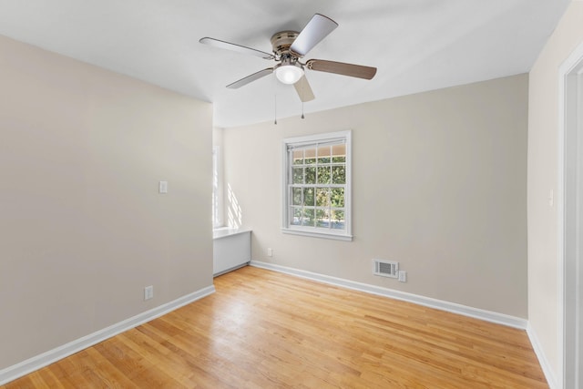 unfurnished room featuring light wood-type flooring and ceiling fan