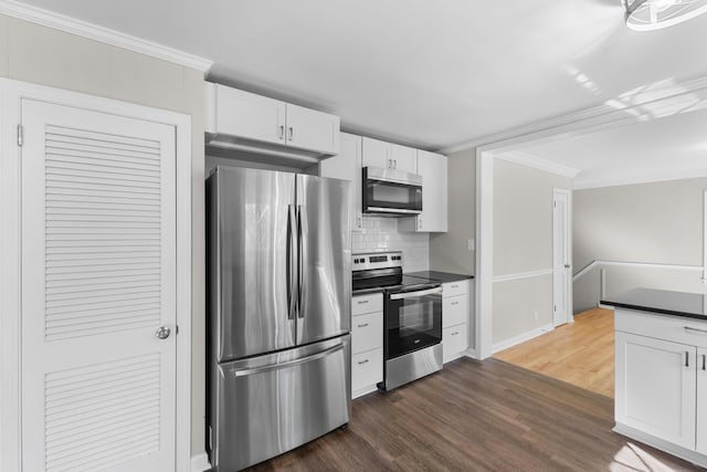 kitchen featuring white cabinetry, ornamental molding, and appliances with stainless steel finishes