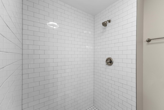 bathroom with tiled shower