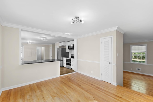 unfurnished living room with light hardwood / wood-style floors and ornamental molding