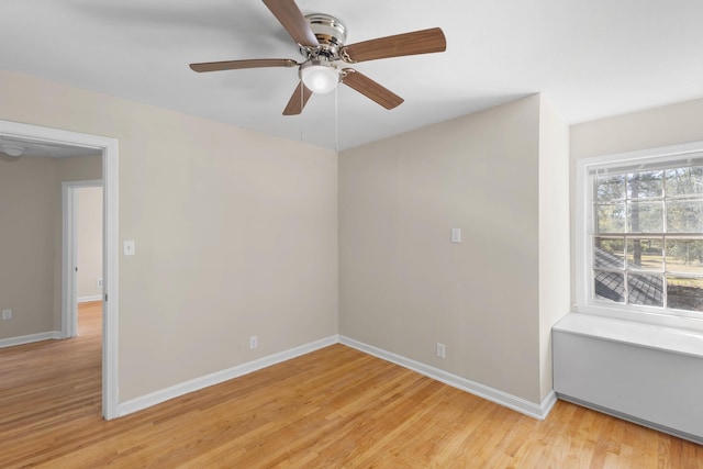 empty room featuring light hardwood / wood-style flooring and ceiling fan