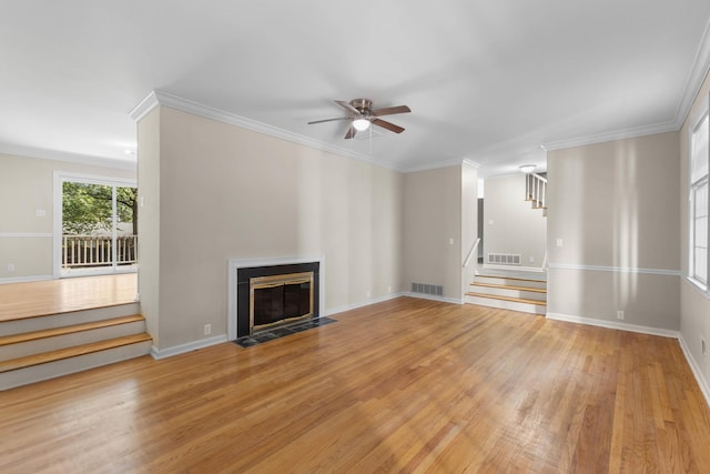 unfurnished living room featuring light hardwood / wood-style flooring, ceiling fan, and crown molding