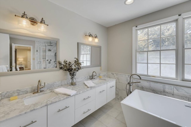 bathroom featuring vanity, tile walls, and independent shower and bath