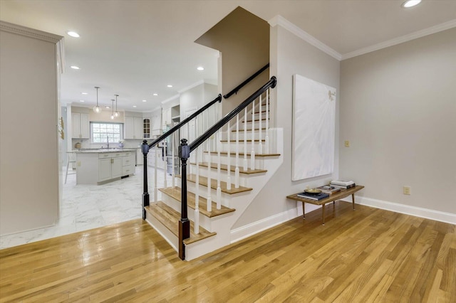 stairs featuring hardwood / wood-style flooring and crown molding