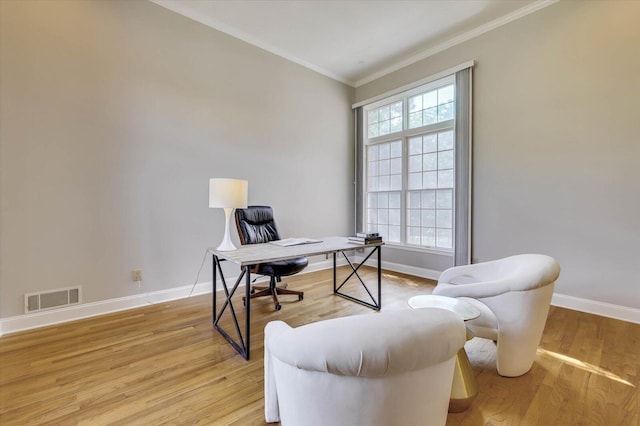 office with crown molding and light hardwood / wood-style flooring