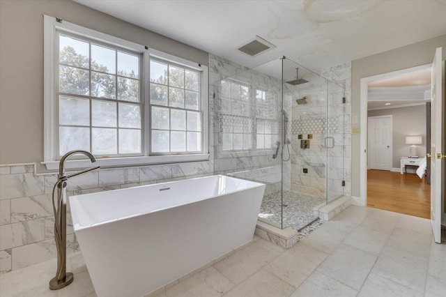 bathroom featuring plus walk in shower and tile walls