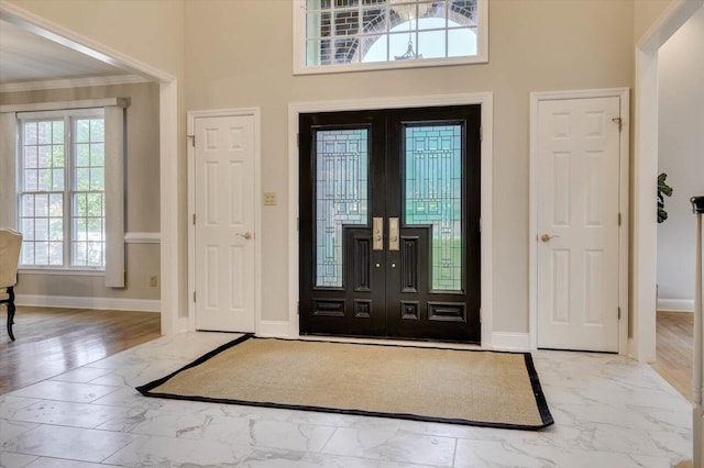 entryway featuring french doors and crown molding