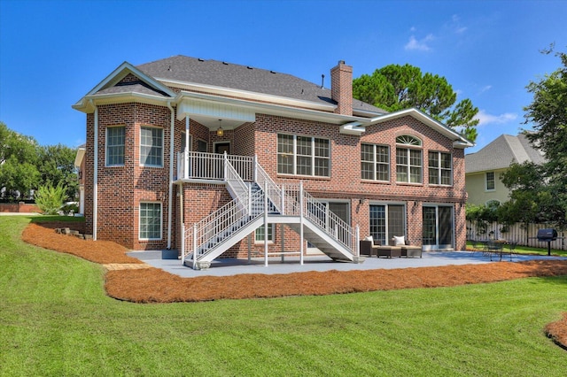 rear view of house featuring an outdoor living space, a yard, and a patio