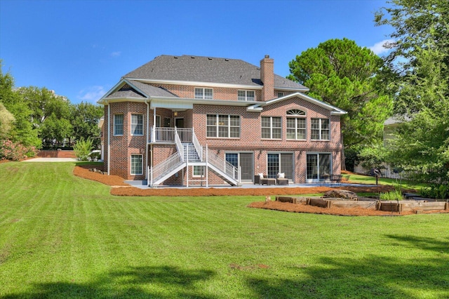 rear view of property with a patio area and a lawn