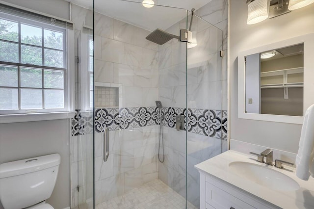 bathroom with vanity, an enclosed shower, and toilet