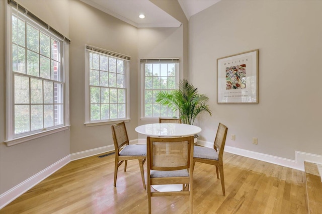 dining area featuring light hardwood / wood-style flooring and vaulted ceiling