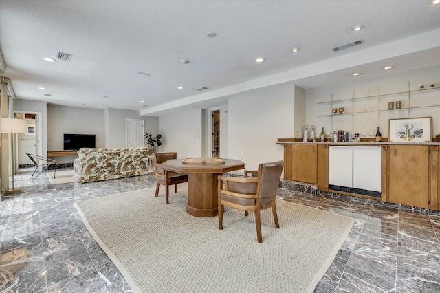 interior space with a textured ceiling and bar area