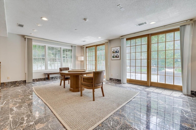 dining space with a textured ceiling