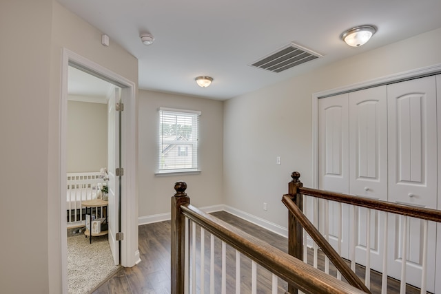 corridor with hardwood / wood-style floors