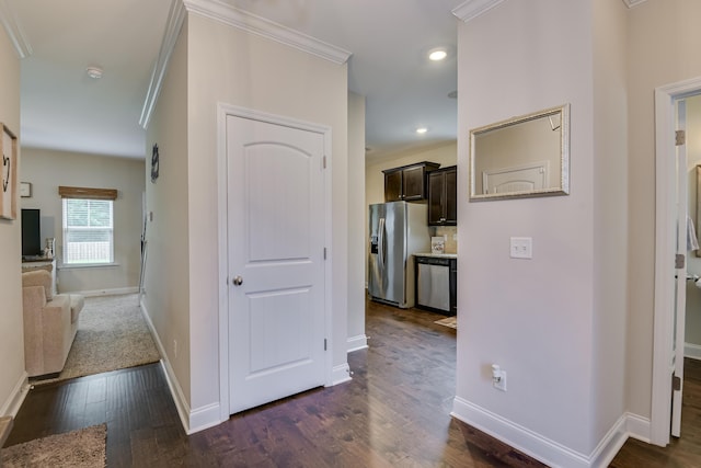 corridor with crown molding and dark hardwood / wood-style flooring