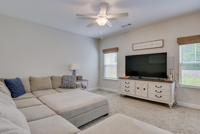 carpeted living room with ceiling fan