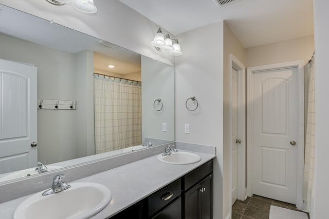 bathroom with tile patterned flooring and vanity