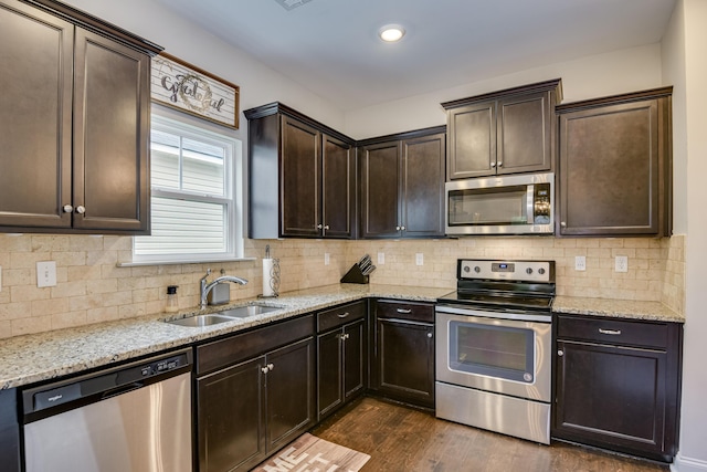 kitchen featuring tasteful backsplash, dark wood-type flooring, dark brown cabinetry, and appliances with stainless steel finishes