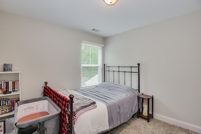 bedroom featuring light colored carpet