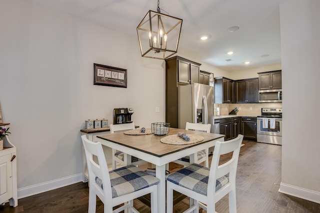 dining room featuring an inviting chandelier and dark hardwood / wood-style floors