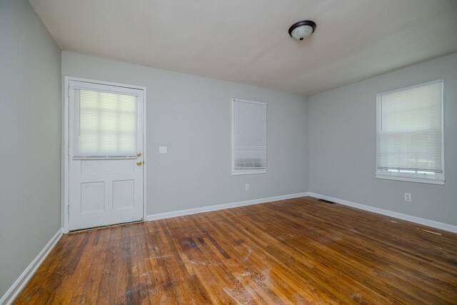 spare room with dark hardwood / wood-style floors