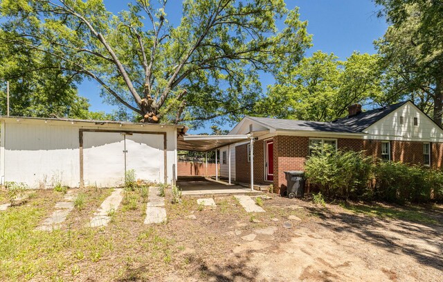 view of property exterior with a carport