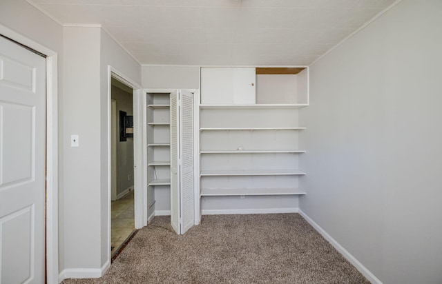 walk in closet featuring light carpet