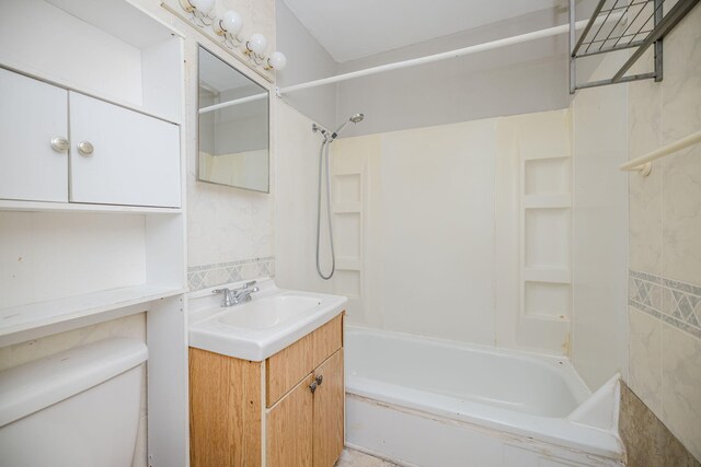 full bathroom featuring vanity, bathing tub / shower combination, and toilet