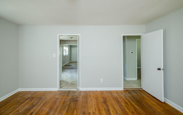 spare room with dark wood-type flooring