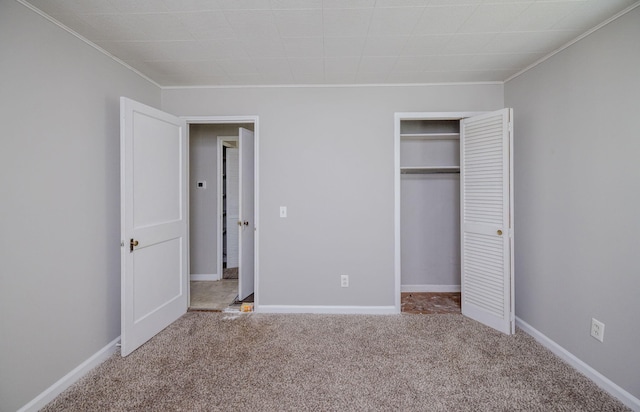 unfurnished bedroom featuring carpet and a closet