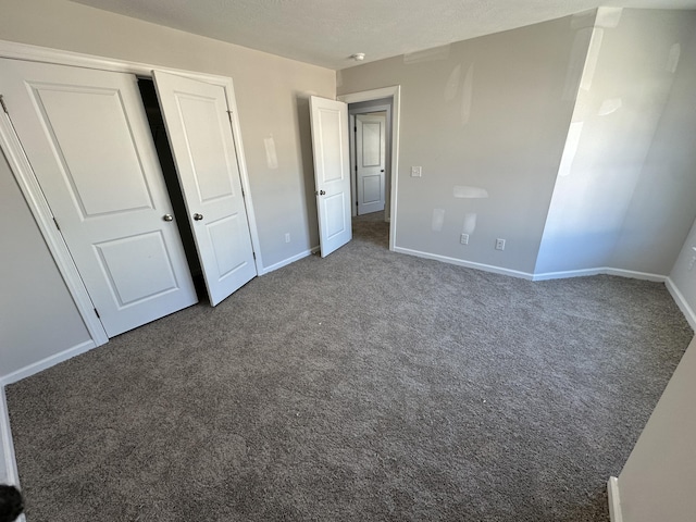 unfurnished bedroom featuring dark colored carpet