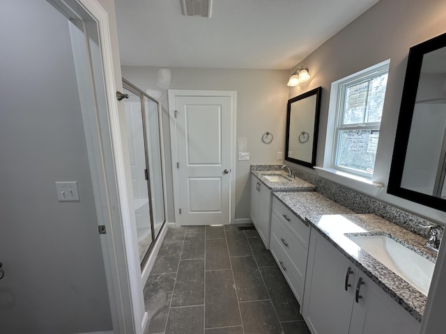 bathroom featuring vanity and an enclosed shower