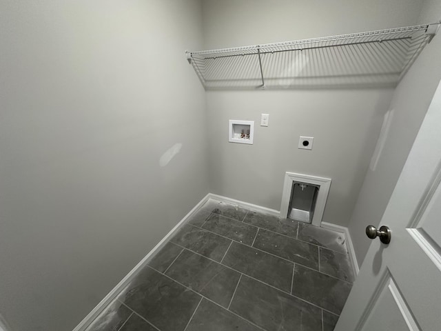 washroom featuring dark tile patterned flooring, hookup for an electric dryer, and hookup for a washing machine