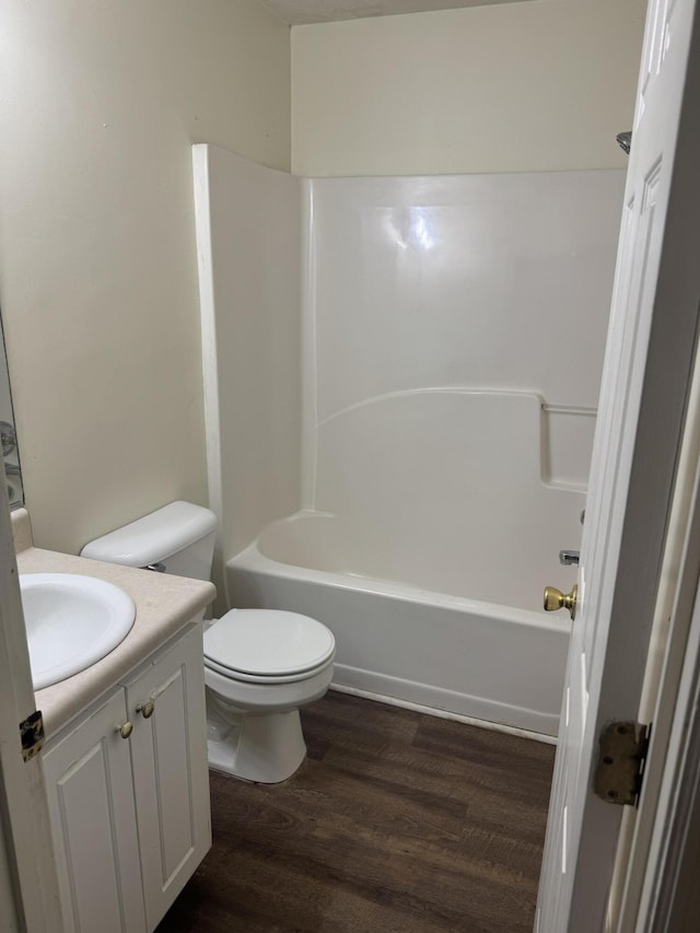 full bathroom with vanity, hardwood / wood-style flooring, toilet, and shower / bathtub combination