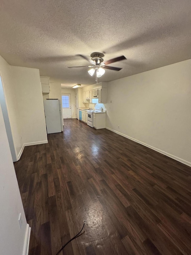 unfurnished living room featuring a textured ceiling, ceiling fan, and dark wood-type flooring