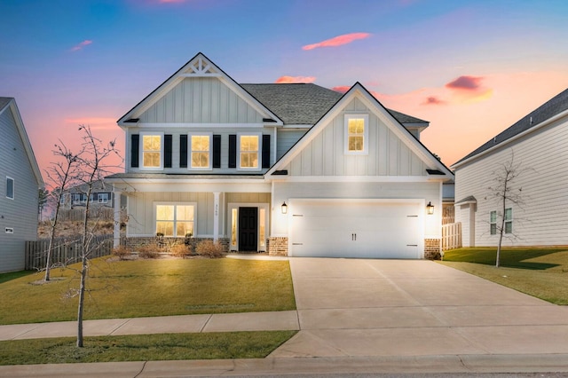 craftsman-style house featuring brick siding, board and batten siding, a front yard, fence, and driveway